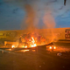 This photo released by the Iraqi Prime Minister Press Office shows a burning vehicle at the Baghdad International Airport following an airstrike in Baghdad, Iraq, early on January 3, 2020.